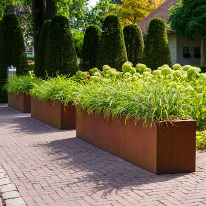 Cortenstahl Blumenkasten bepflanzt auf Öffentlichem Platz.